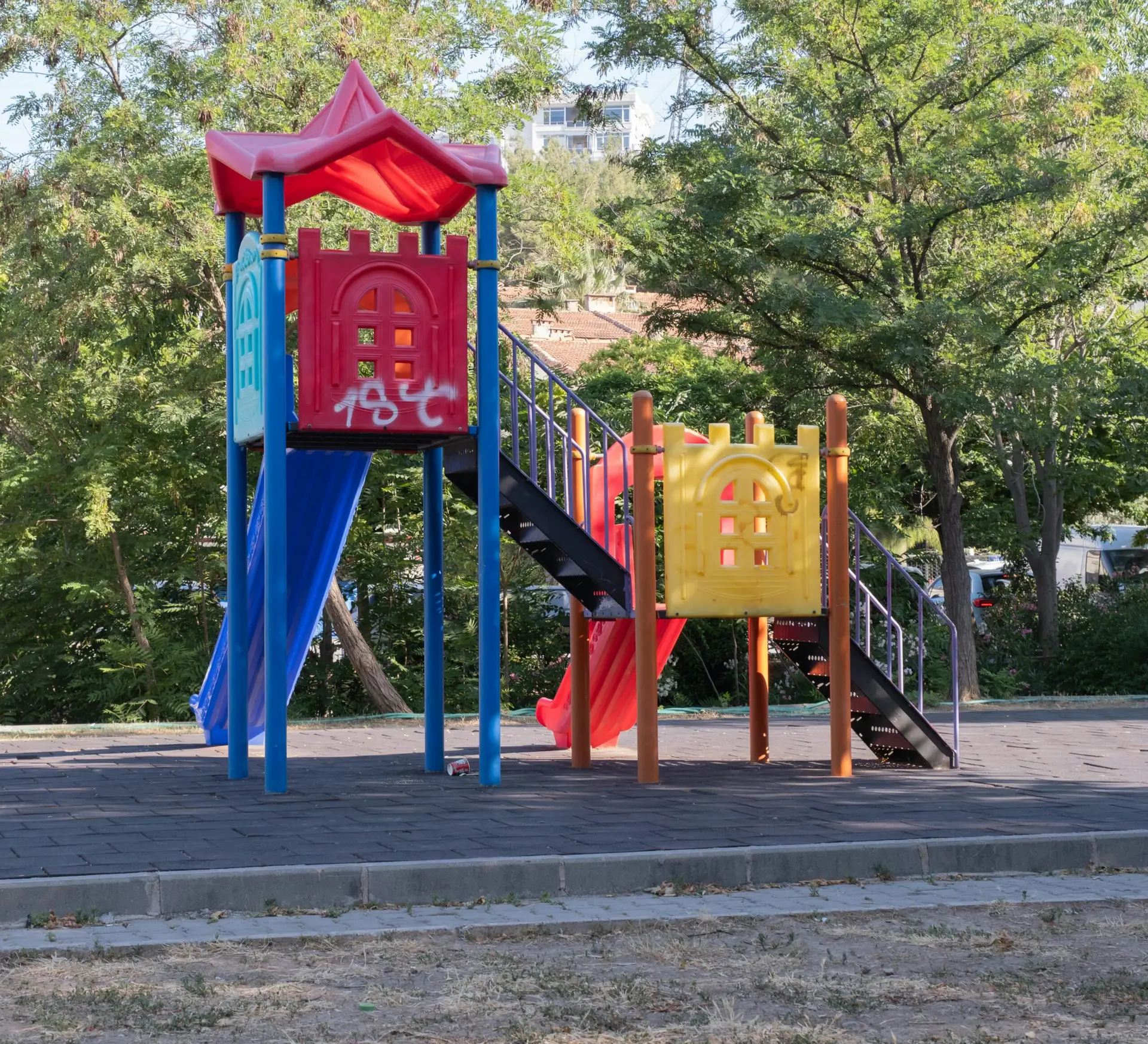 Vibrant playground equipment in a sunny İzmir park, ideal for kids' outdoor activities.